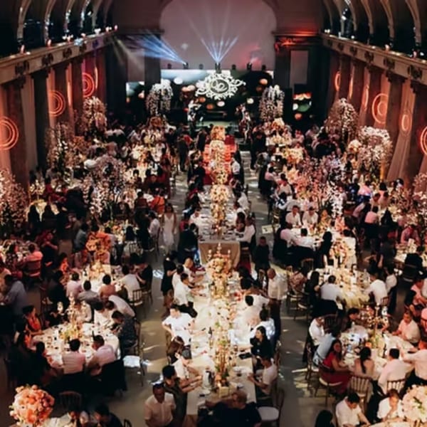 Grand ballroom filled with guests seated at elegantly decorated tables for a large event.